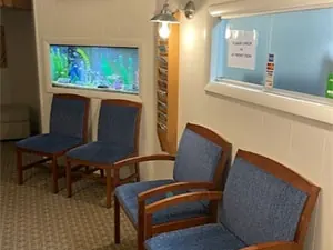 The waiting room at Sicher Family Dentistry, with a Welcome sign and an aquarium set into the wall.