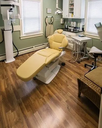 A second treatment room at Sicher Family Dentistry, with sage walls and a dental chair.
